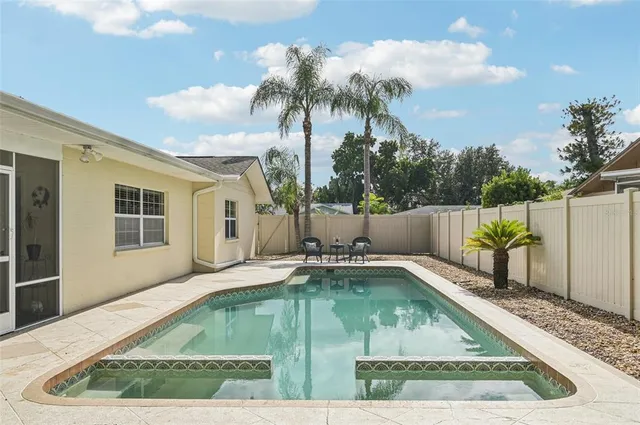 a view of swimming pool with outdoor seating