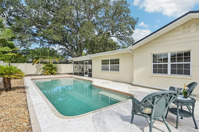 a front view of a house with swimming pool having outdoor seating