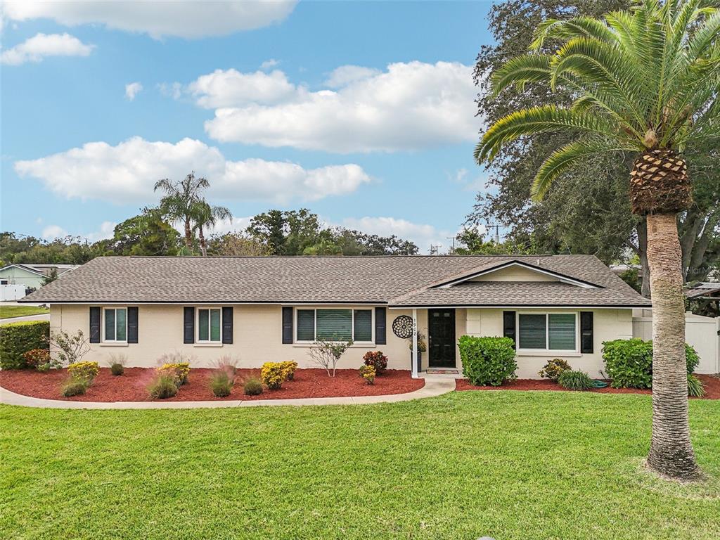 1908 49th Street West Bradenton, FL 34209 - Photo 45 of 57 a front view of a house with a garden