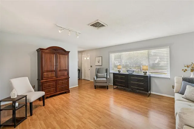a living room with furniture and wooden floor