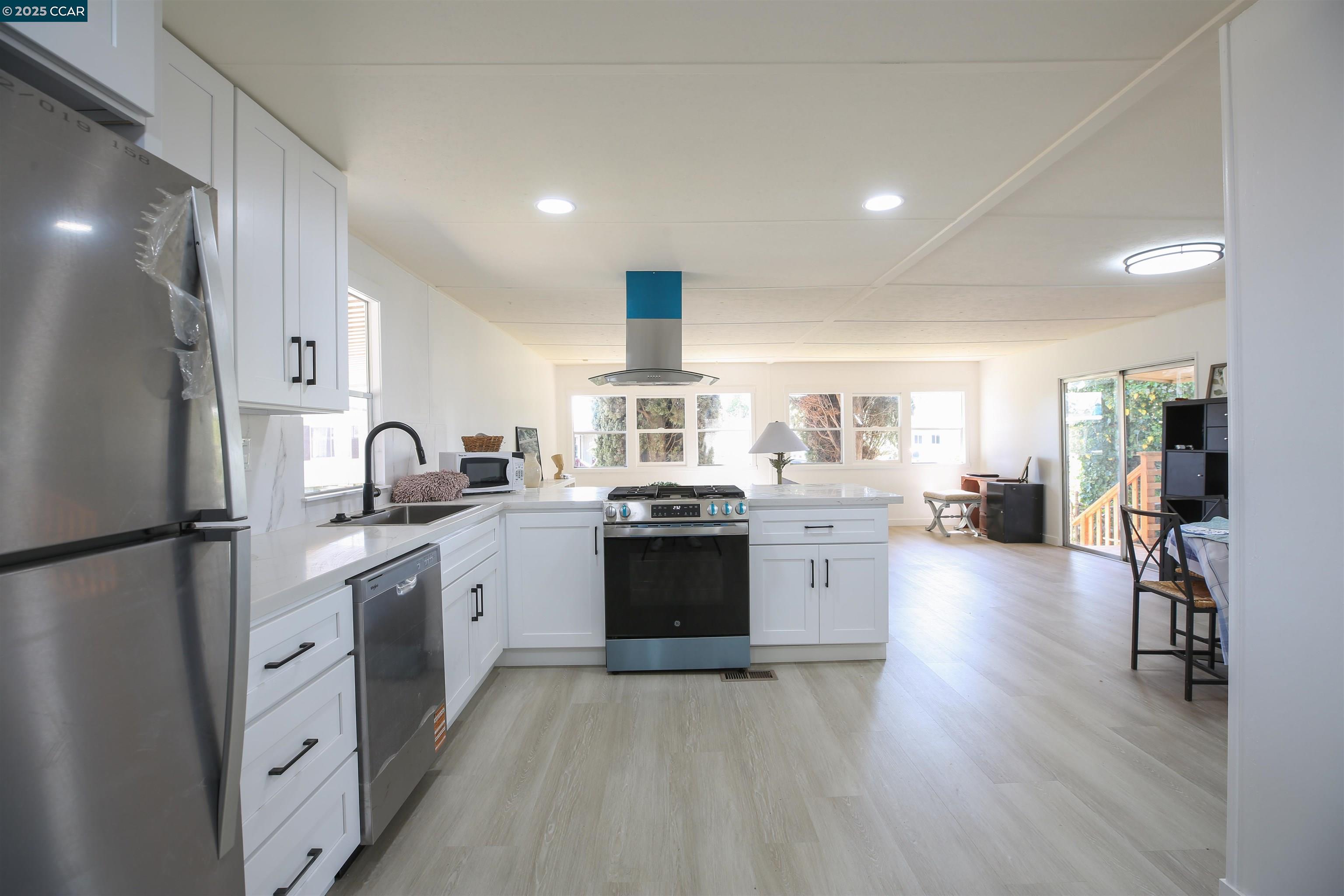 a kitchen with sink cabinets and stainless steel appliances