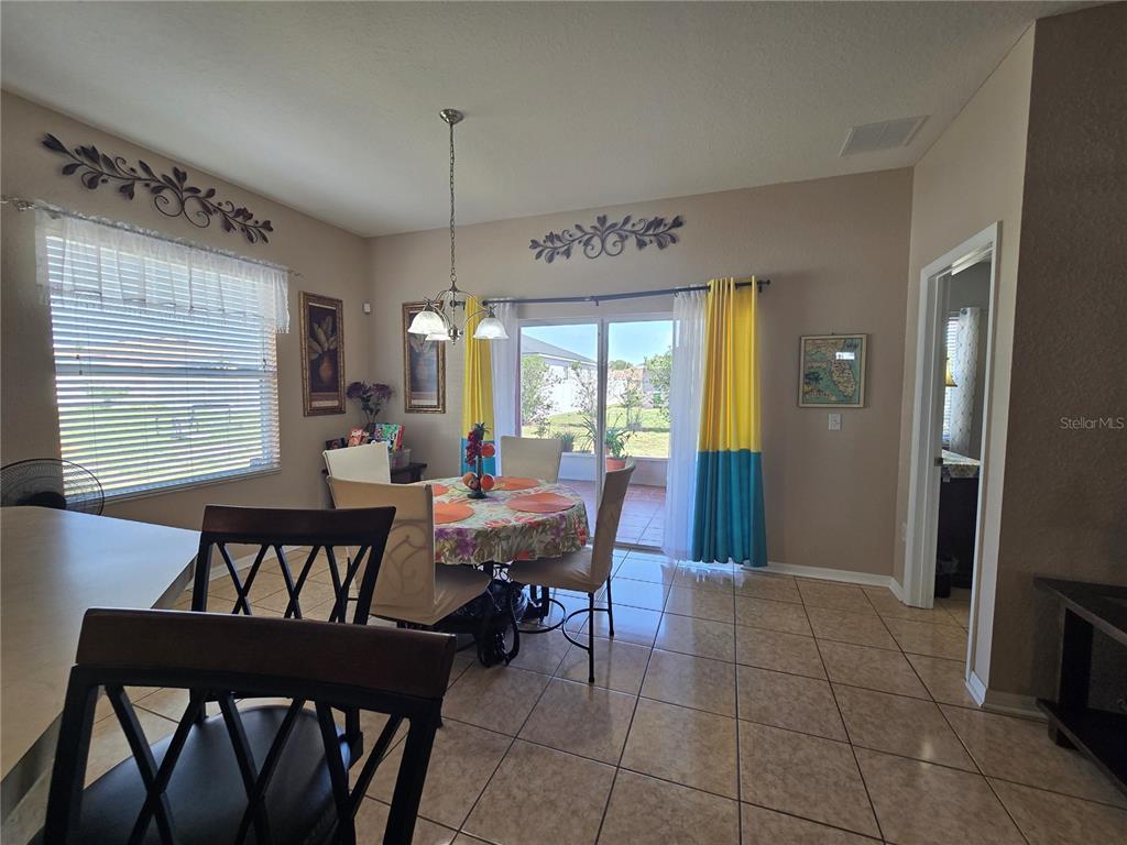 219 Cloverdale Road Winter Haven, FL 33884 - Photo 7 of 29 a view of a dining room with furniture window and wooden floor