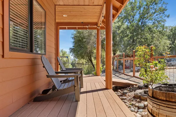 a view of a balcony with chairs and wooden floor