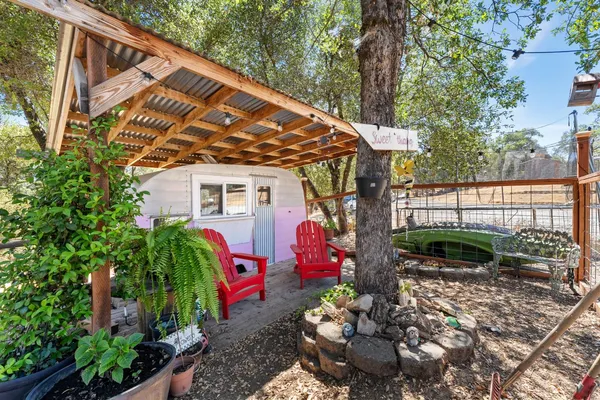 a blue bench sitting in the middle of a yard
