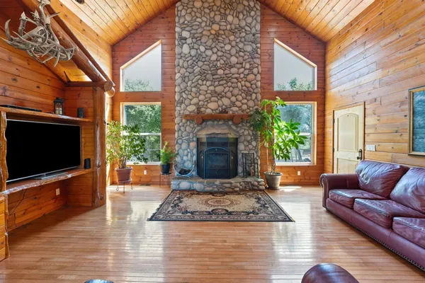 a living room with fireplace furniture and a flat screen tv