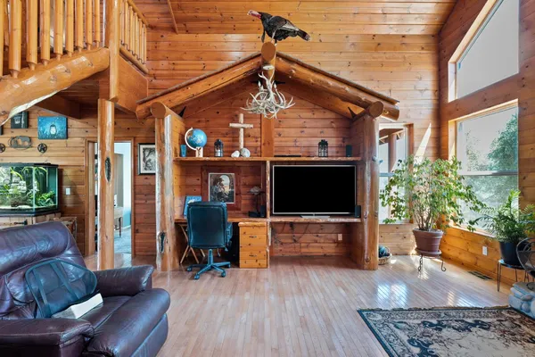 a view of entryway livingroom and hall with wooden floor