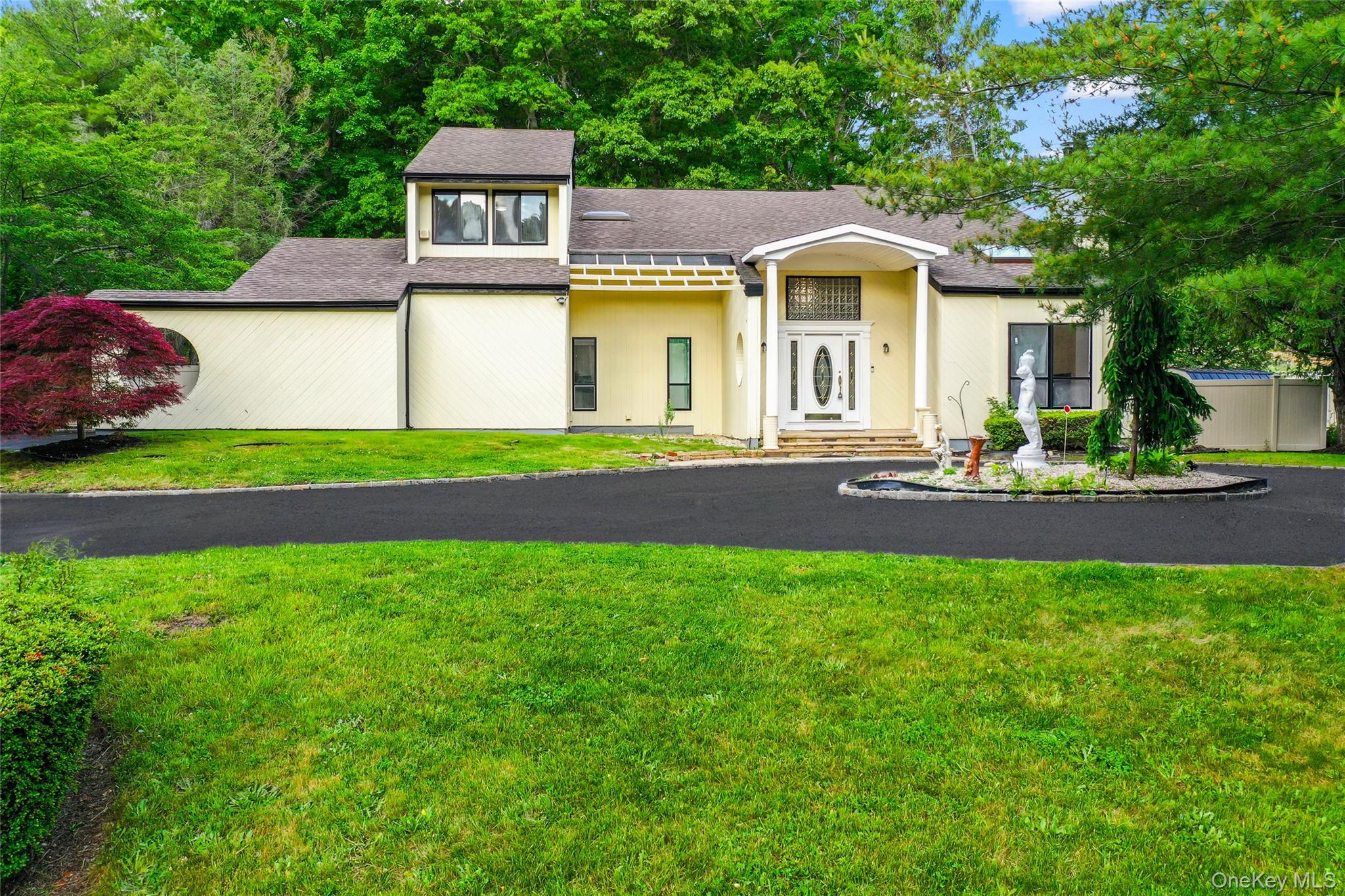 126 Bagatelle Road Melville, NY 11747 - Photo 2 of 50 a front view of a house with a garden