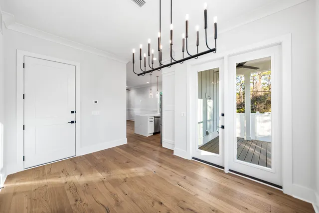 a view of an entryway with wooden floor