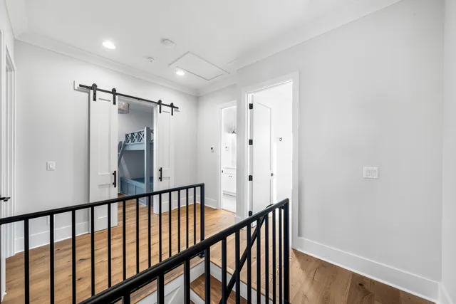 a view of a hallway with wooden floor