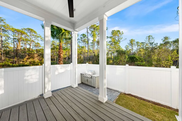 a view of a living room with furniture and floor to ceiling window