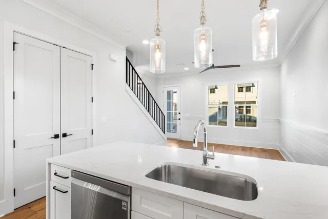 a kitchen with stainless steel appliances a sink a stove and a window