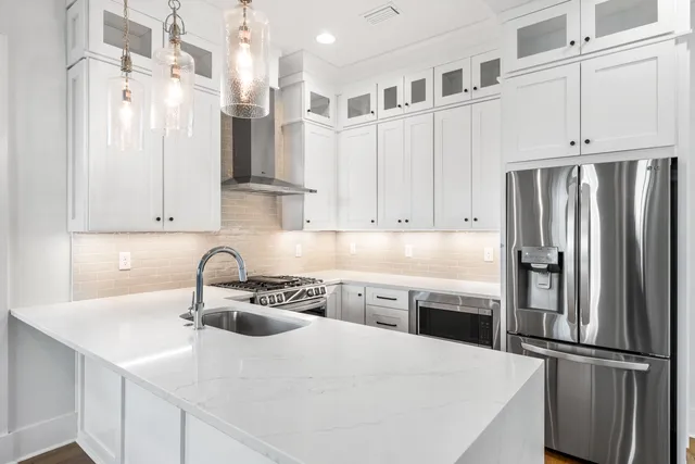 a kitchen with stainless steel appliances a refrigerator sink and cabinets