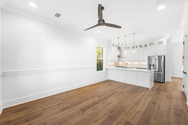 a view of a kitchen with wooden floor