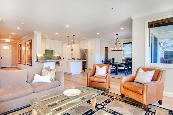 a living room with furniture and kitchen view
