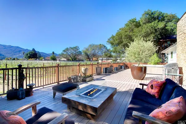 a view of a balcony with wooden floor and outdoor seating