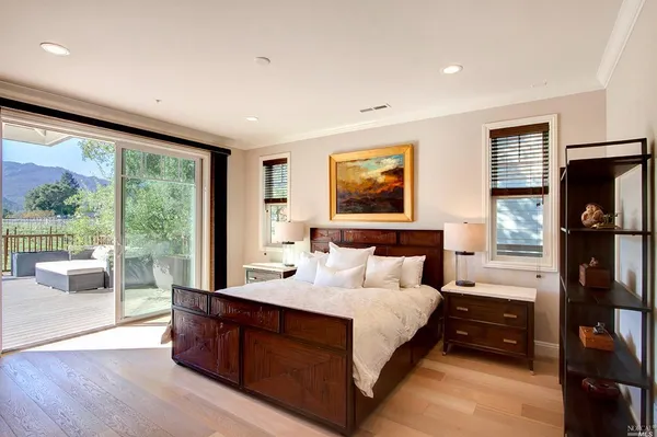 a bedroom with a bed and a large window