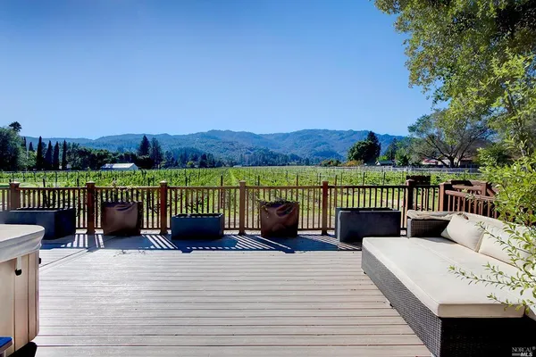a view of a balcony with wooden floor and fence