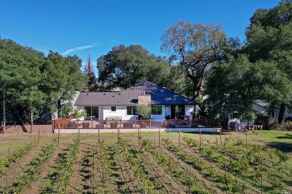 a front view of a house with a yard table and chairs