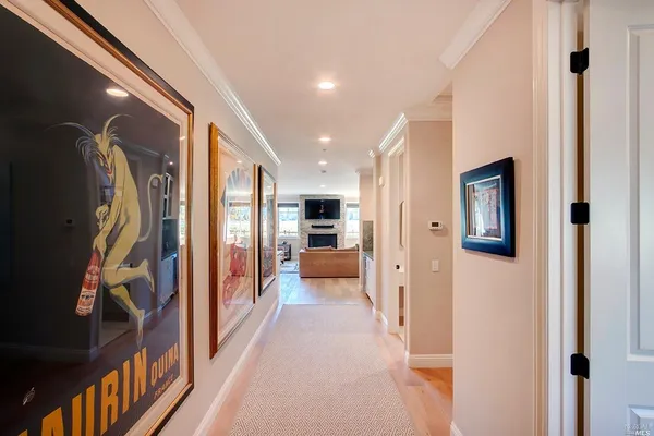 a view of a hallway with wooden floor and windows