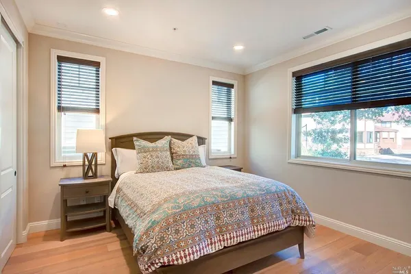 a bedroom with a large bed and a window