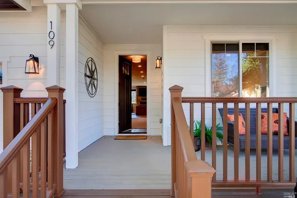 a view of a hallway with wooden door and stairs