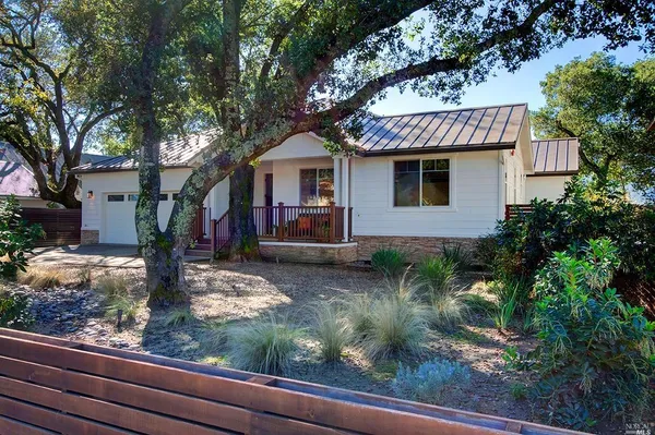 a front view of a house with garden