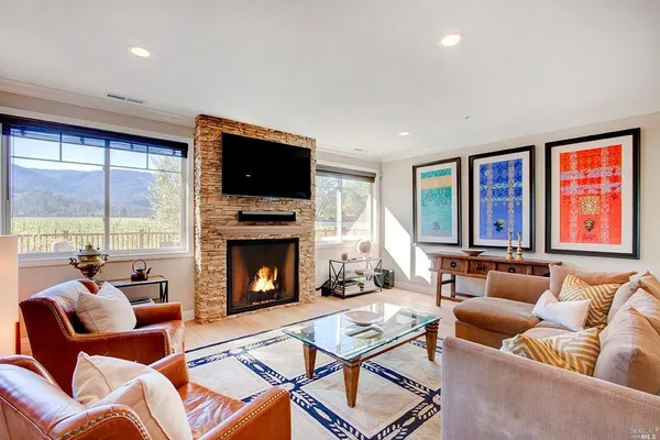 a living room with furniture fireplace and flat screen tv
