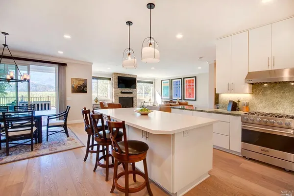 a large kitchen with a table and chairs