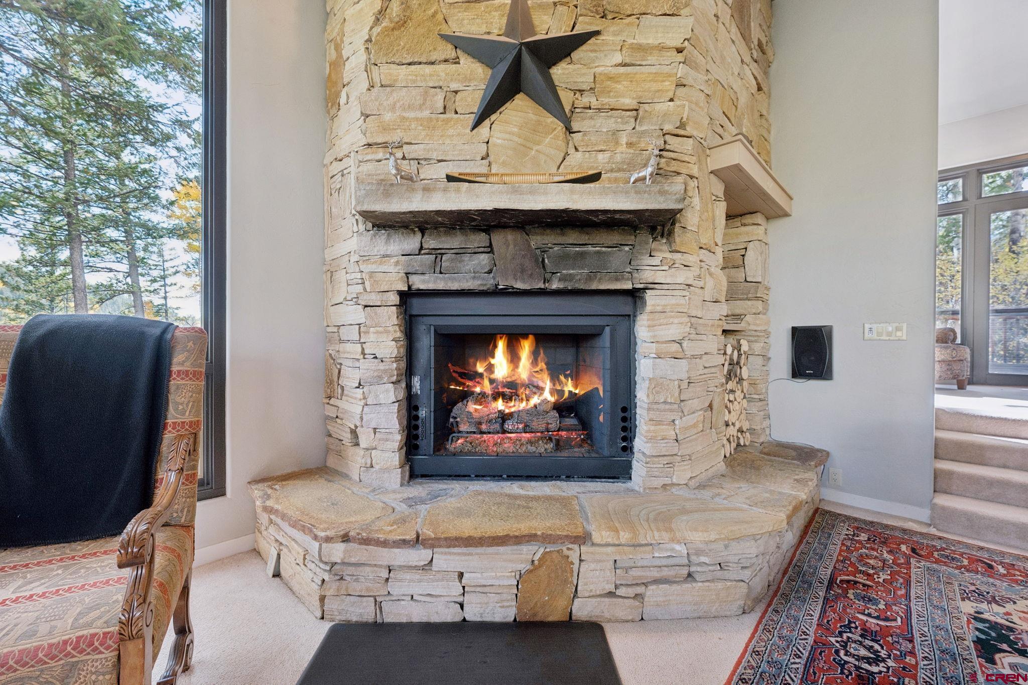 333 Beaver Circle Durango, CO 81301 - Photo 12 of 45 a living room with furniture a fireplace and a flat screen tv
