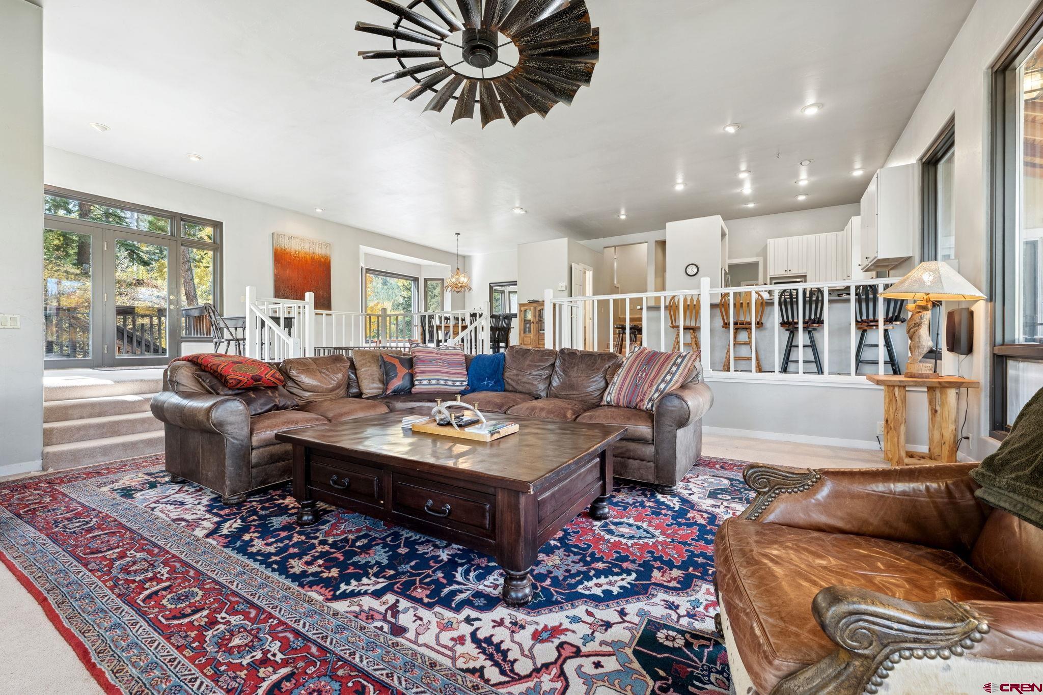 333 Beaver Circle Durango, CO 81301 - Photo 13 of 45 a living room with furniture a rug and a chandelier