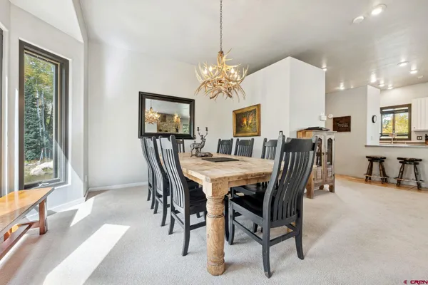a view of a a dining room with furniture window and outside view