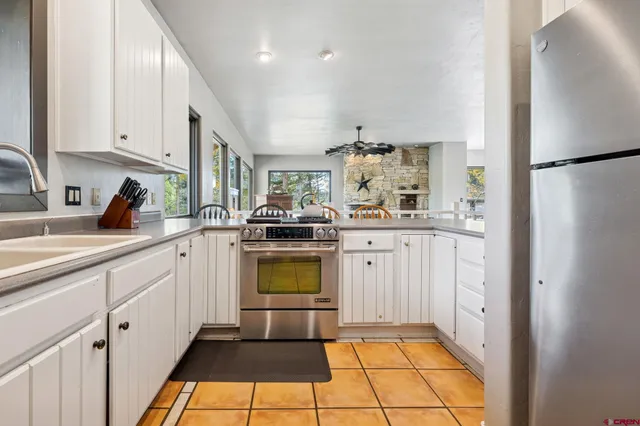 a kitchen with a sink cabinets and stainless steel appliances