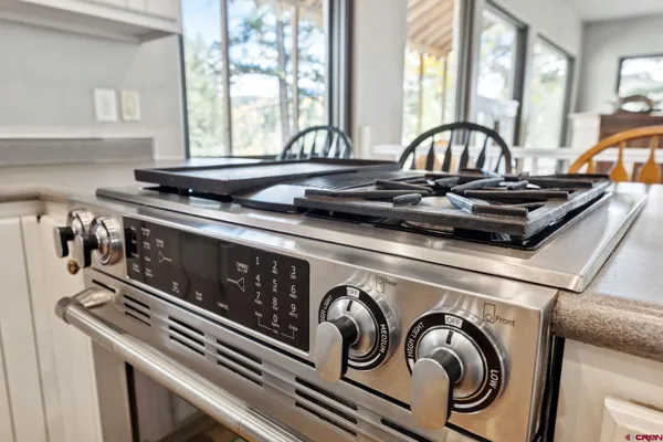 a view of a kitchen sink stove and cabinets