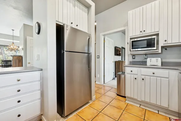 a kitchen with stainless steel appliances white cabinets and a refrigerator