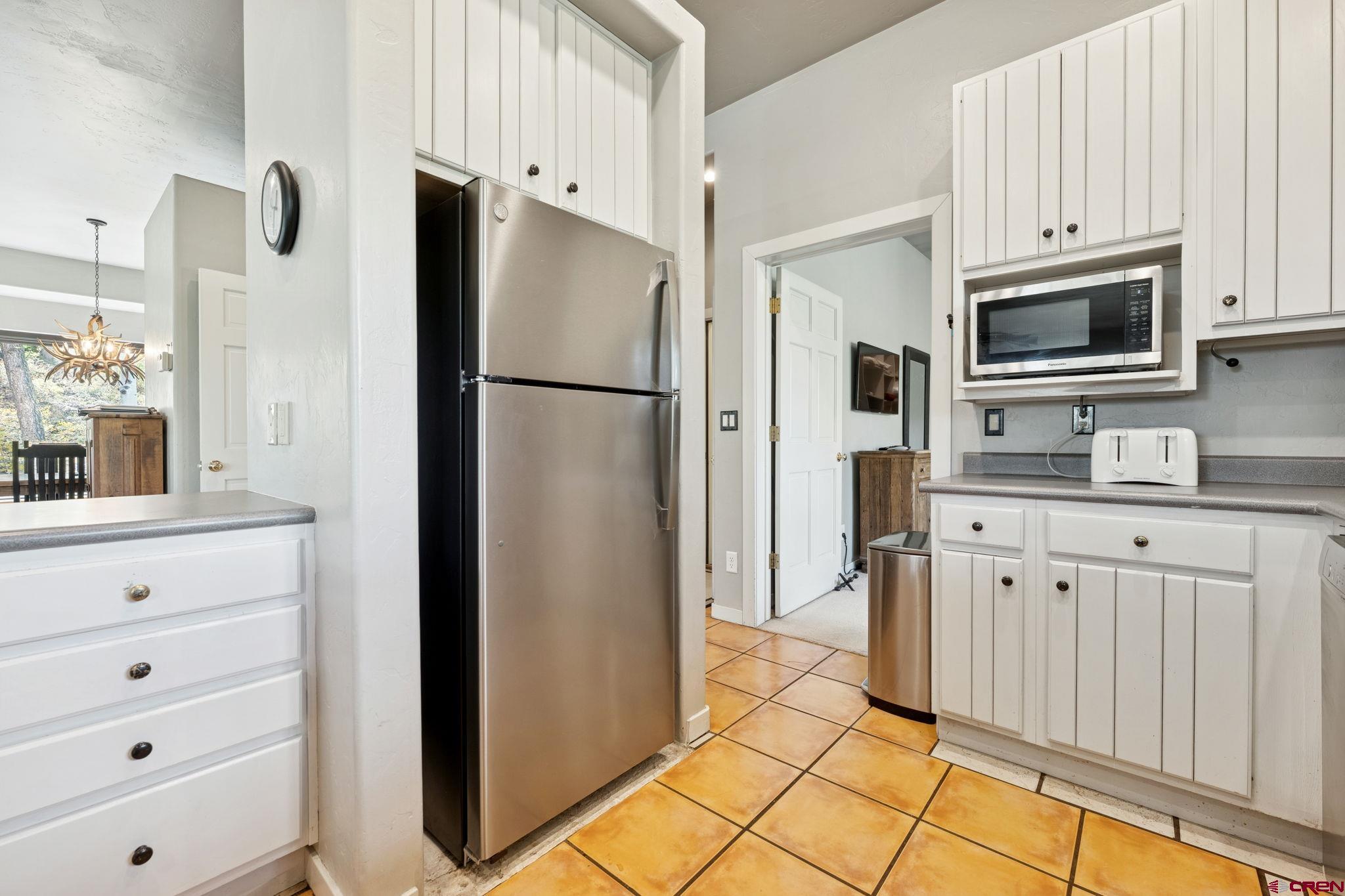 333 Beaver Circle Durango, CO 81301 - Photo 20 of 45 a kitchen with stainless steel appliances white cabinets and a refrigerator