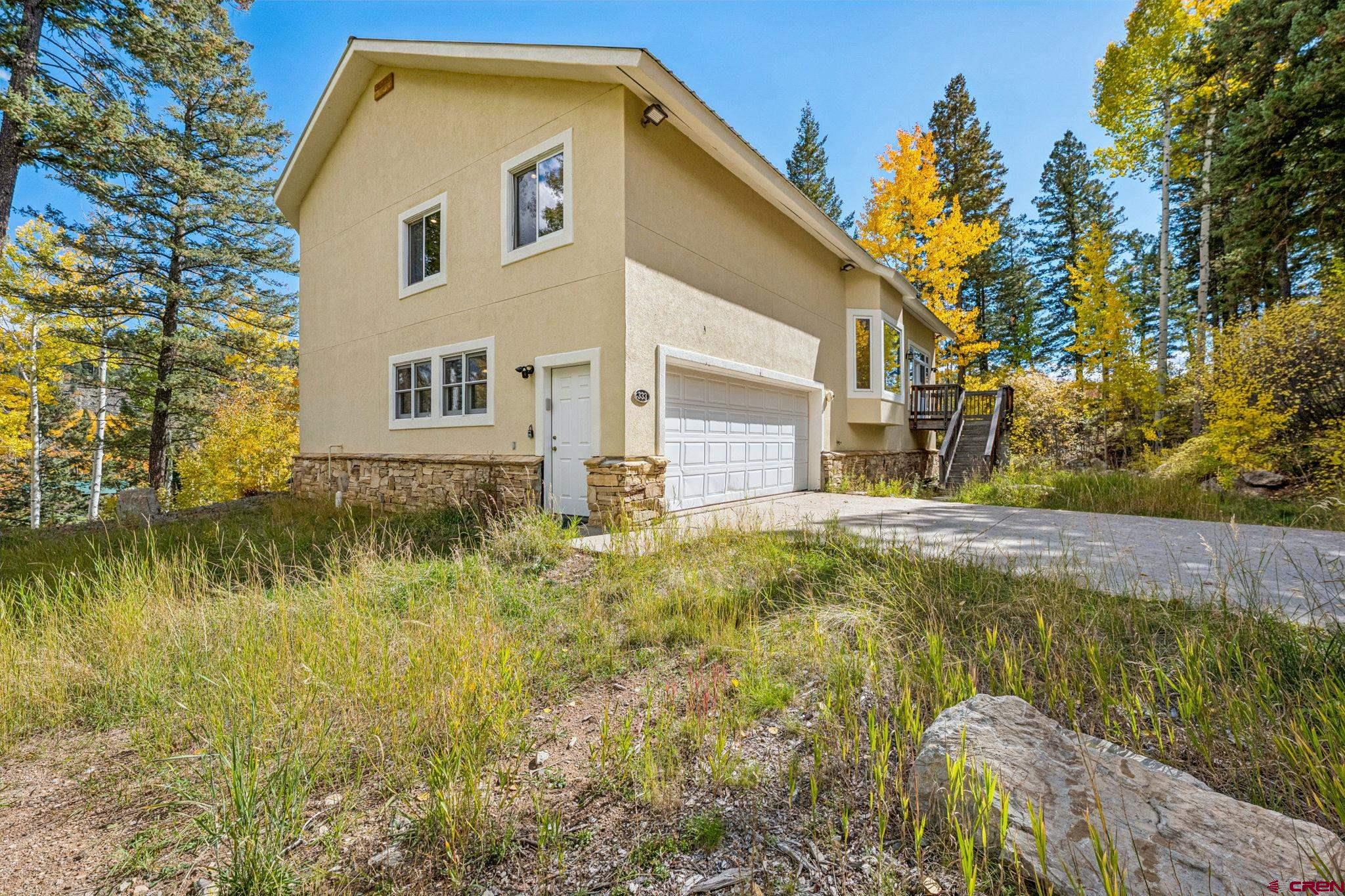 333 Beaver Circle Durango, CO 81301 - Photo 2 of 45 a front view of a house with garden