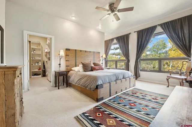 a bedroom with a large bed and a chandelier