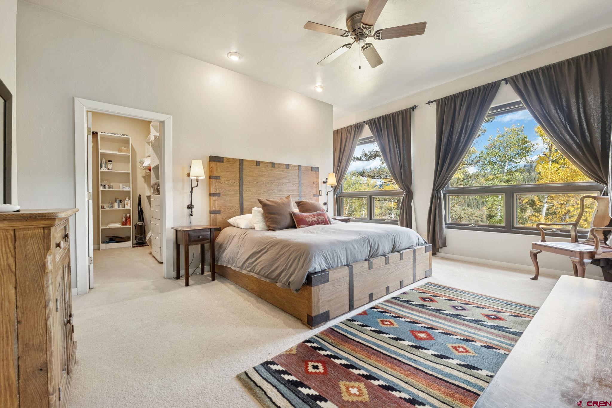 333 Beaver Circle Durango, CO 81301 - Photo 22 of 45 a bedroom with a large bed and a chandelier