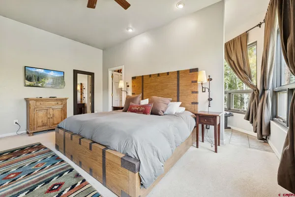 a bed room with a bed and a television