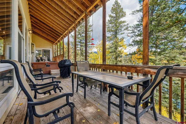 a view of a chairs and table in the balcony
