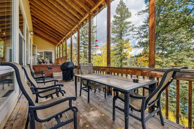 a view of a chairs and table in the balcony