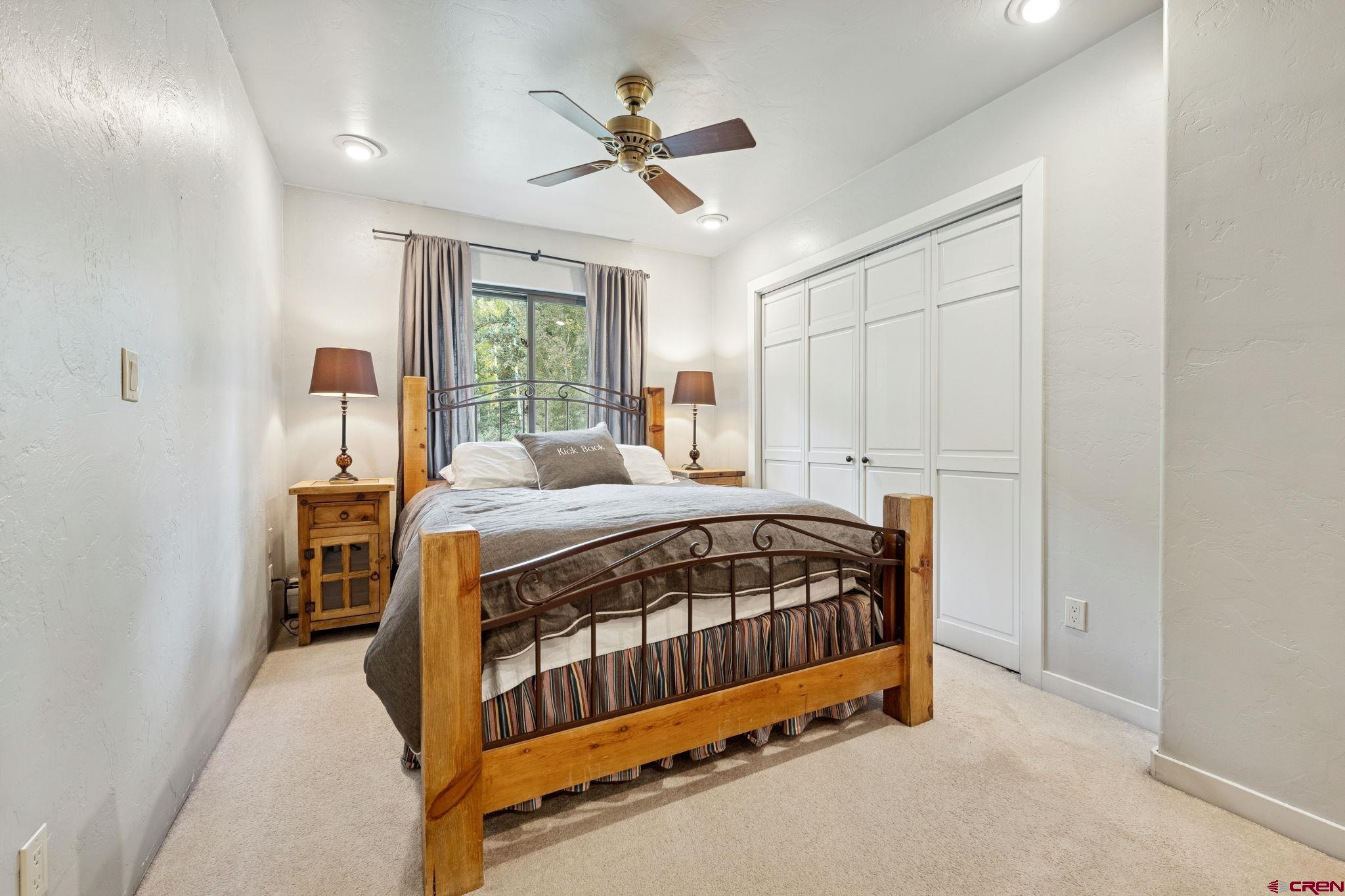 333 Beaver Circle Durango, CO 81301 - Photo 30 of 45 a bedroom with a bed and a chandelier