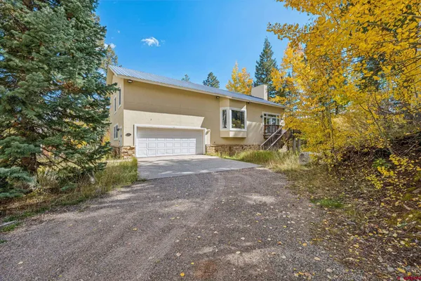 a view of a house with a yard and garage
