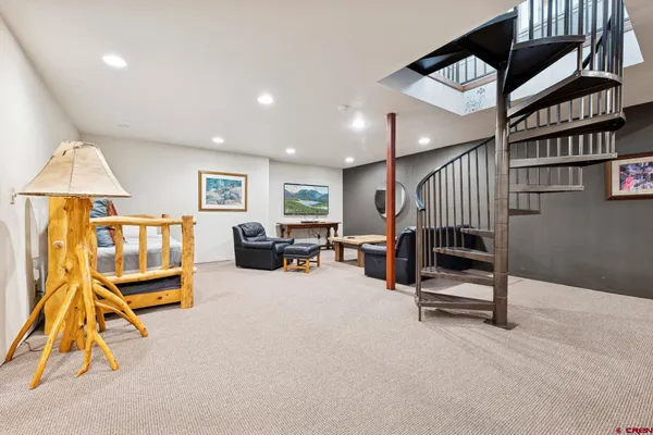 a living room with furniture and a gym equipment