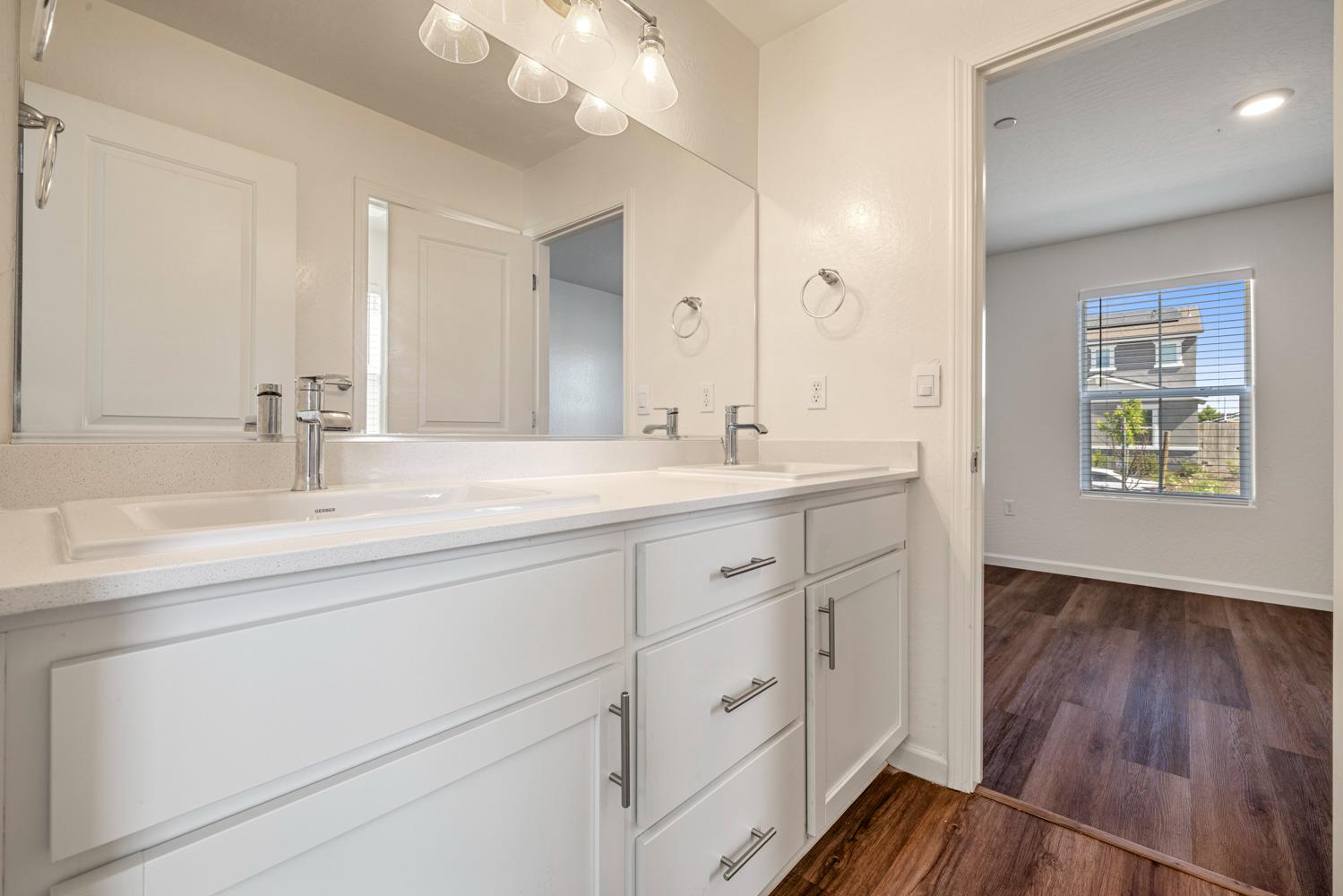 342 Rubicon Court Merced, CA 95341 - Photo 11 of 40 a bathroom with a double vanity sink and a mirror