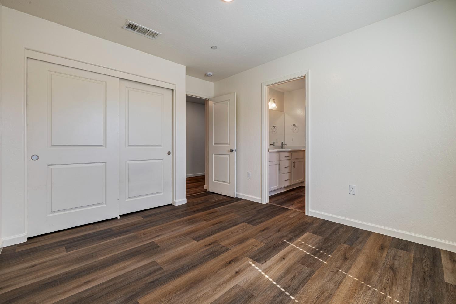 342 Rubicon Court Merced, CA 95341 - Photo 12 of 40 a view of an empty room with wooden floor