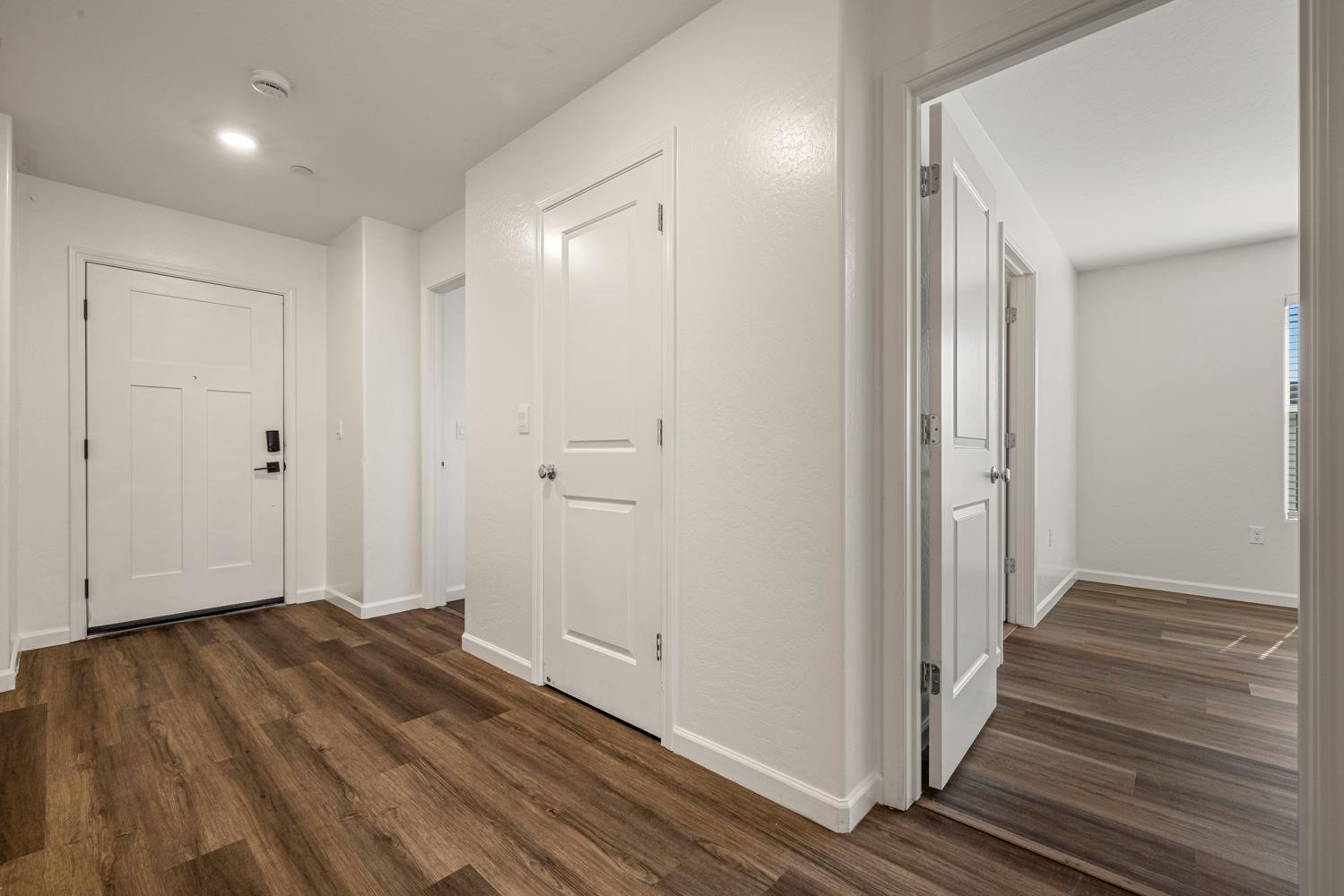 342 Rubicon Court Merced, CA 95341 - Photo 14 of 40 a view of a hallway with wooden floor and staircase