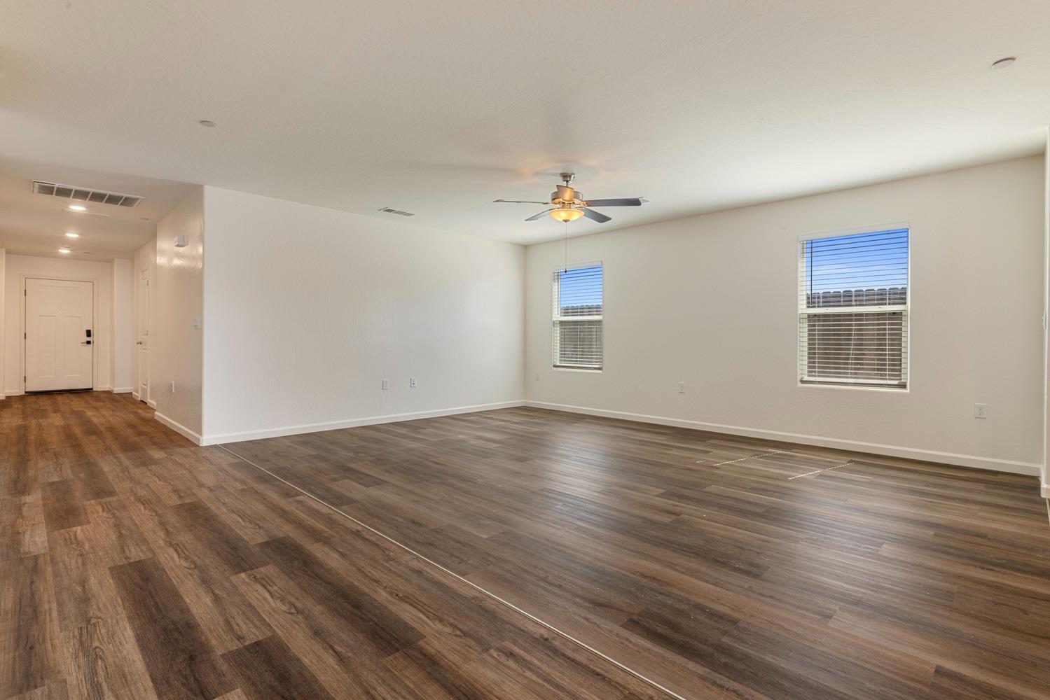 342 Rubicon Court Merced, CA 95341 - Photo 18 of 40 a view of empty room with wooden floor and fan