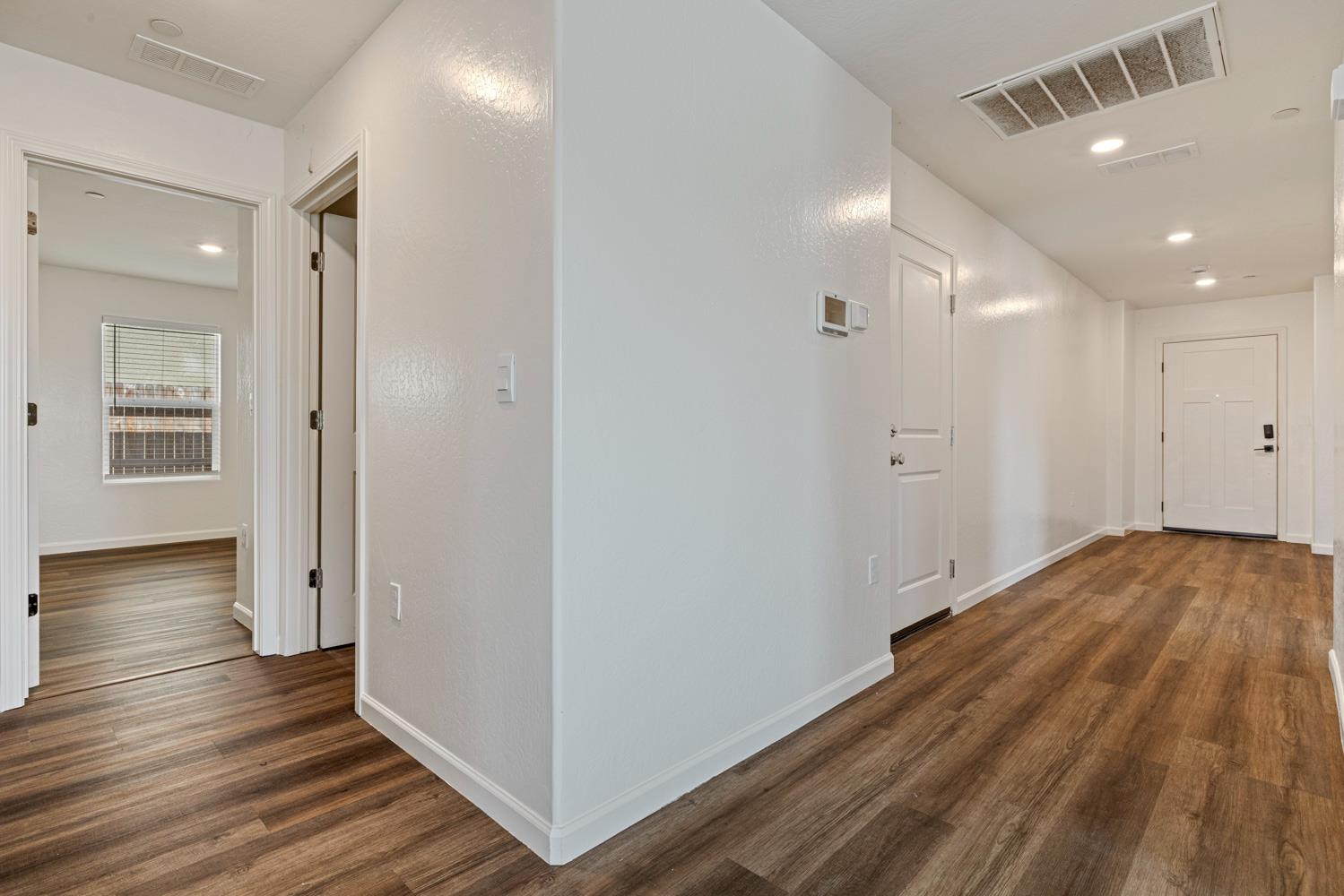 342 Rubicon Court Merced, CA 95341 - Photo 19 of 40 a view of a hallway with wooden floor