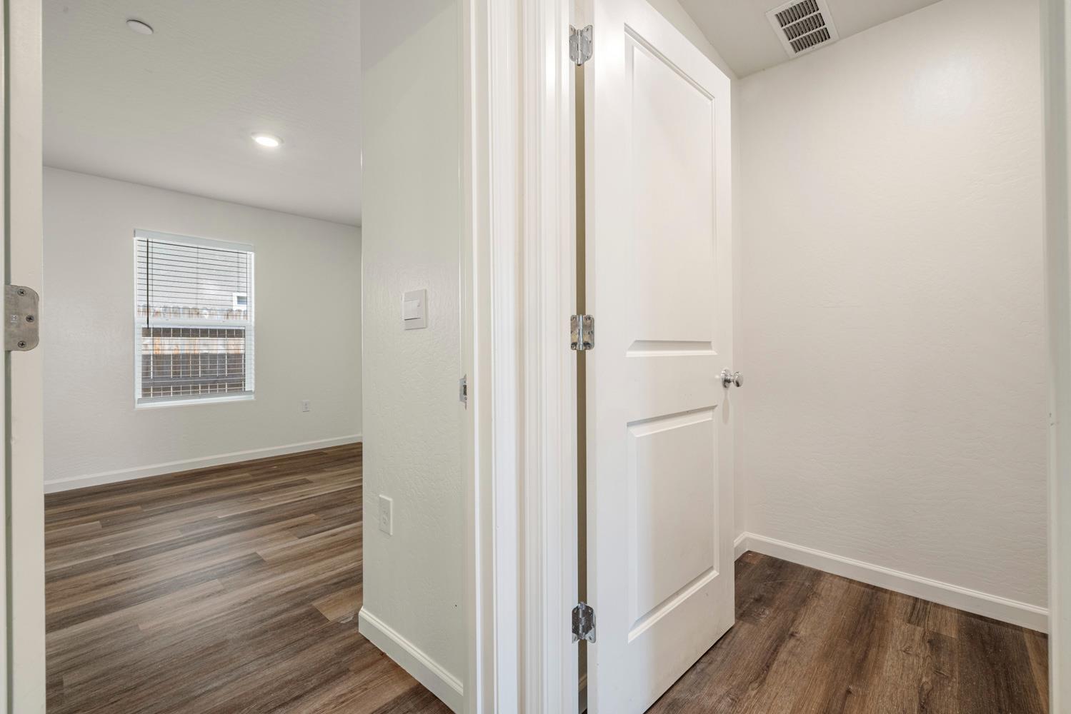 342 Rubicon Court Merced, CA 95341 - Photo 23 of 40 a view of hallway with window and wooden floor